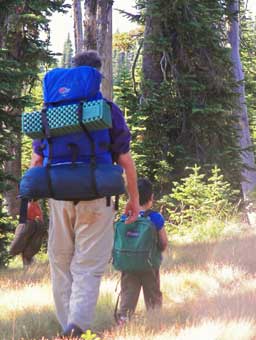 Mark and his son, Karun walking with packs on